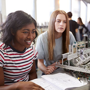 Two girls studying robotics