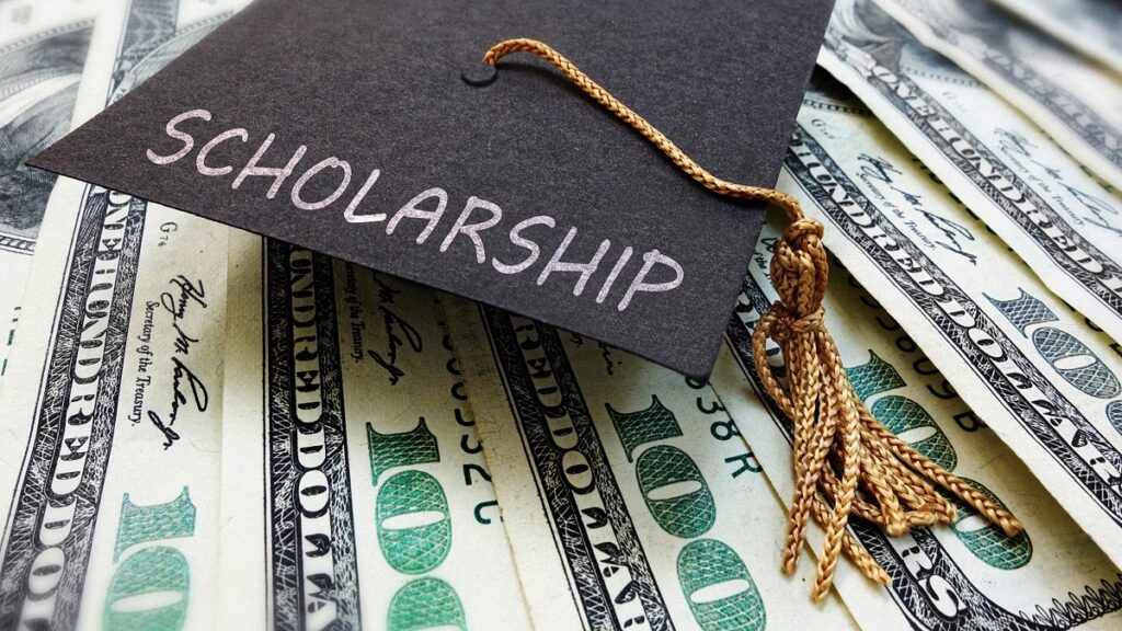 graduation cap with scholarship money