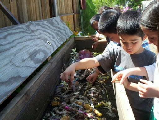 kids looking inside a dirt-pit