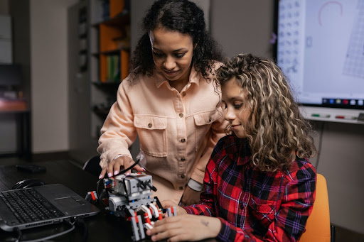 Parent and child playing with a robot