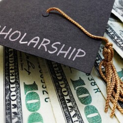 graduation cap with scholarship money
