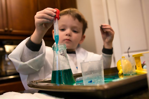 Little boy working with chemicals 