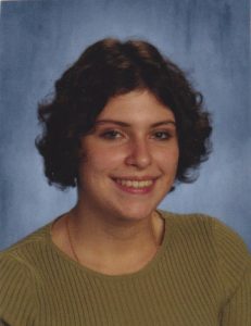 A headshot picture of a woman