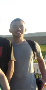 A picture of a boy in gray shirt.