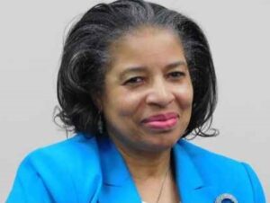 A woman wearing a blue coat.